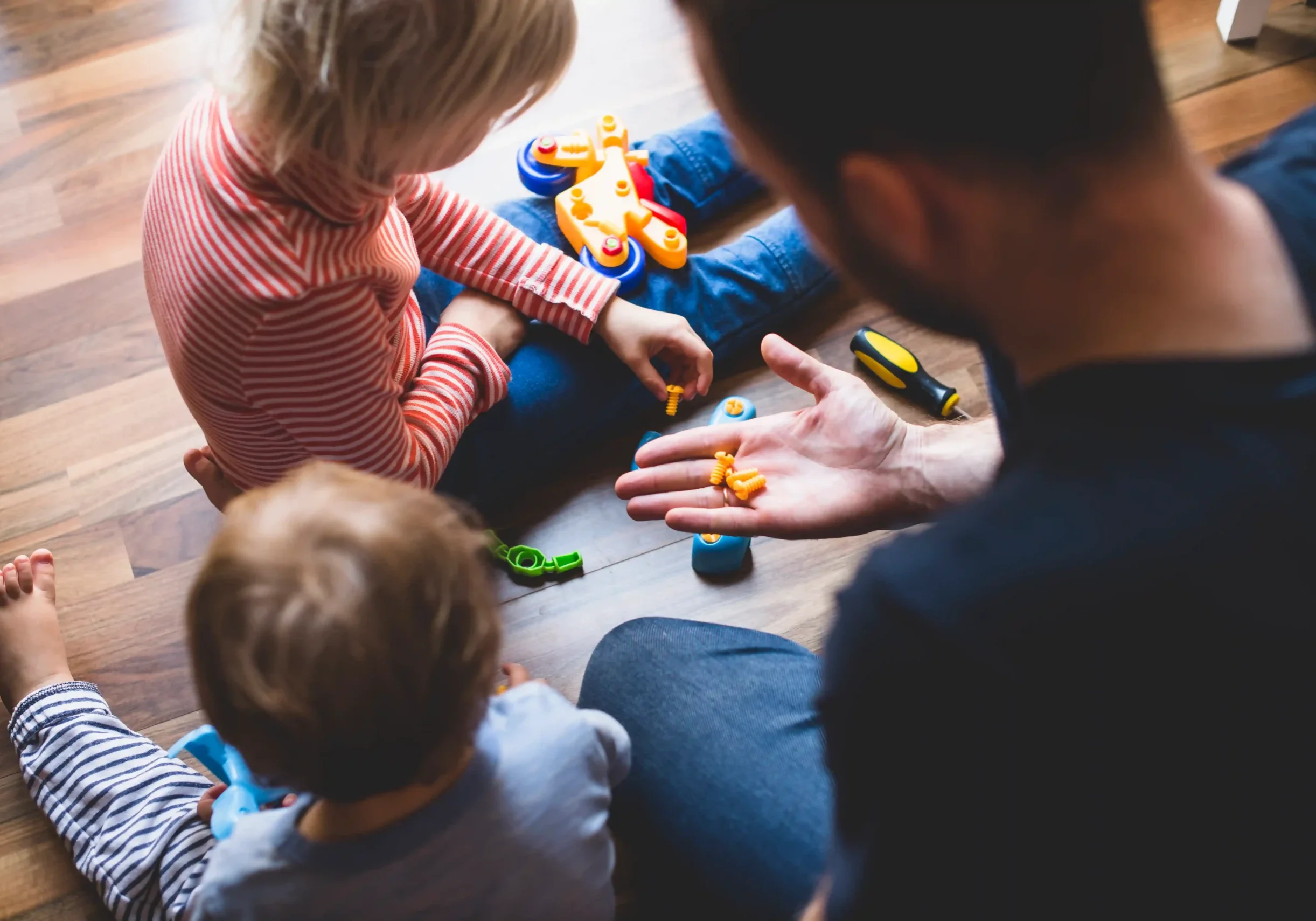 rear-view-father-playing-with-his-children