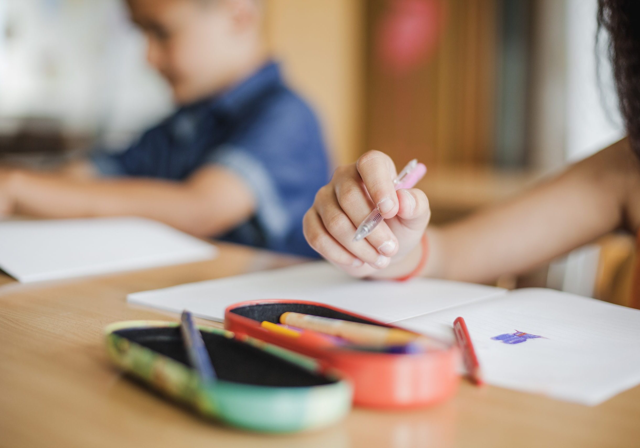 schoolchildren-sitting-desk-with-notebooks